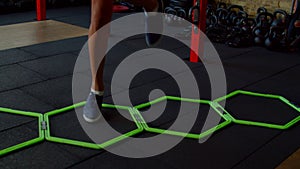 Close-up of female legs doing cardio intense workout using agility ladder