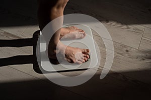 Close-up of female legs on electronic scales.