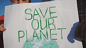 Close up of female and male hands of young couple holding placards of movement for saving planet. Family of eco