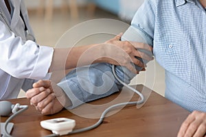 Close up of female nurse measure blood pressure with monitor