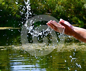 Close-up female palms toss water