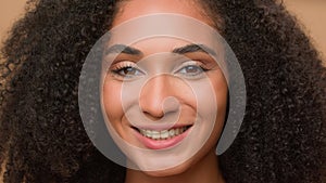 Close up female perfect face clean smooth skin make-up smiling happy African American woman model girl beautiful lady
