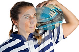 Close up of female player holding rugby ball while looking away