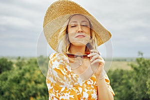 Close up of female portrait of attactive blonde girl closed her eyes and enjoys moment