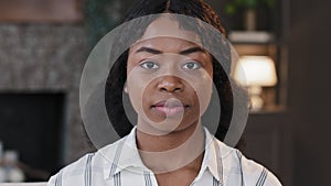 Close up female portrait indoors african 20s student girl 30s millennial woman wife girlfriend mother looking at camera