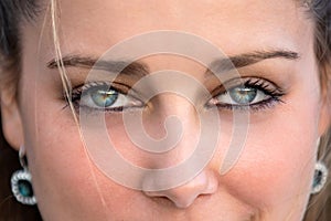 Close up female portrait on intense piercing blue eyes, confident, flirtatious, seductive, sensual stare