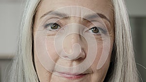 Close up female portrait old lady blonde grey-haired mature woman wise grandma beautiful elder 50s wrinkled housewife