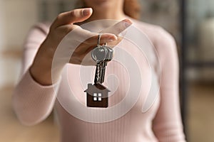 Close up of female renter show keys to new home