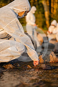 Close-up of female scientist collecting water sample from sea