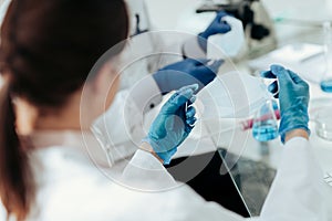 Close up. female scientist putting on a protective mask .