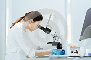 Close up. female scientist using a microscope in the lab.