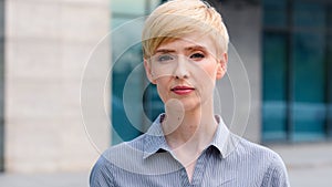 Close-up female serious face portrait outdoors caucasian middle aged business woman boss blonde short haired leader