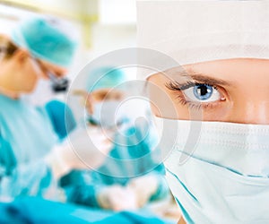 Close-up of a female surgeon with his team