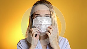 Close up of a female surgeon`s face wearing surgical mask