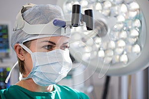 Close-up of female surgeon wearing surgical loupes