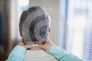 Close-up of female therapist massaging neck to male patient