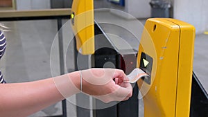 Close up of a female validating a Metro ticket at a station in Prague