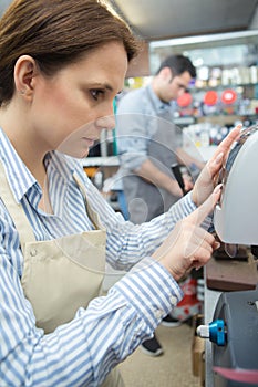 Close up female worker programming machine