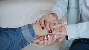 Close up of female young hands holding an elderly woman`s hands