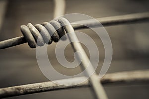 Close-up of fence from metal netting with melancholic blurry background