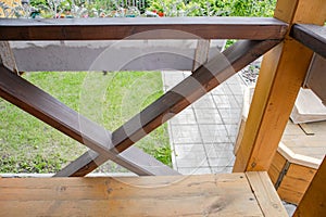 Close-up of the fence on the porch of the terrace, view from the inside. blurred summer garden background