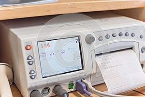 Close-up fetal monitor with baby heart beats at labor room hospital