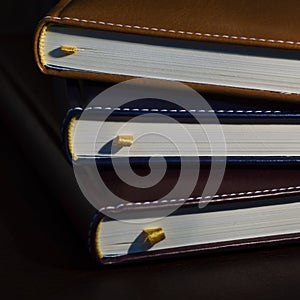 Close-up of a few colored books notebooks, diaries photo