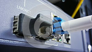 Close up fiber optic cable connect to network device.