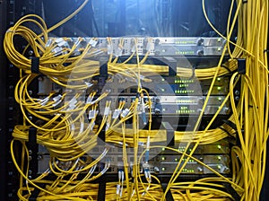 Close up fiber optic cable. Servers racks. Severs computer in a rack at the large data center.