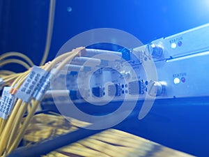 Close up fiber optic in server room , network cables installed in the rack.