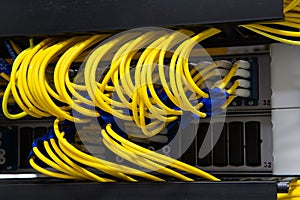 Close up fiber optic in server room , network cables installed in the rack Abstract image for use as a background