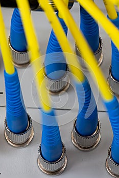 Close up fiber optic in server room , network cables installed in the rack Abstract image for use as a background