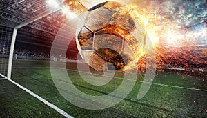 Close up of a fiery soccer ball kicked with power at the stadium scoring a goal