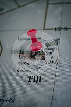 Close up of Fiji pin pointed on the world map with a pink pushpin