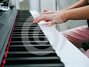 Close-up Finger playing piano keyboard.