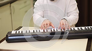 Close up of Fingers, Hands are playing digital electronic Piano Synthesizer.