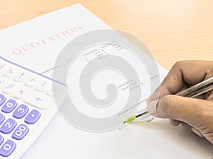 Close up fingers holding a pen to sign on document