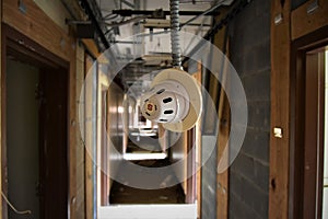 Close up of fire alarm hanging in the abandoned barracks at Sawyer KI AFB