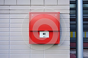close-up of a fire alarm pull station on a wall