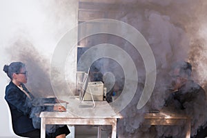 Close-up of fire burning inside the office cabin during works. Men and women office workers in a fire. Short circuit and