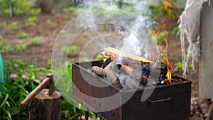 Close up of fire on chargrill. Dry sticks smoulder. Concept of cooking on grill.