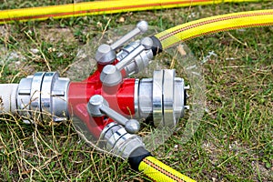 Close-Up of a Fire Hose Dividing Manifold on Grass