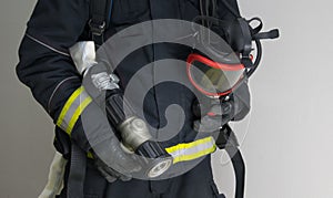 Close-up of a firefighter with specialized equipment for extinguishing fires in a smoky area