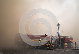 Close up of firemen in action in a city center.