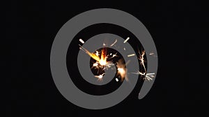 Close-up of firework sparkler burning. Fireworks burn on a black background. Slow motion shot