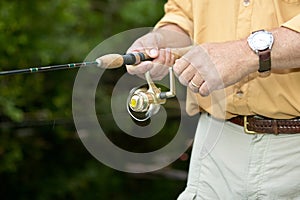 Close up of fisherman using fishing reel