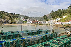 Close up of fishing tackle in the port of tazones in asturias, spain. in the background you can see the white houses on a sunny