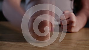 Close up Fist of angry child beats on the table in slow motion. Little kid girl angry.