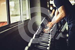 Close up of fit young hand caucasian big muscle in sportswear.