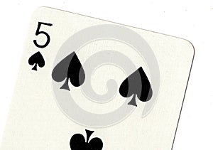 Close up of a five of spades playing card.